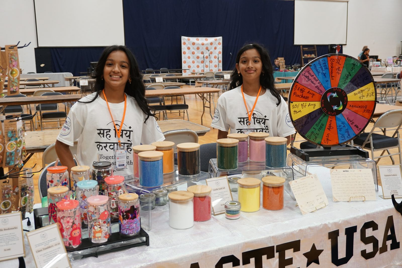 Kidpreneurs at their booth with products and a prize wheel