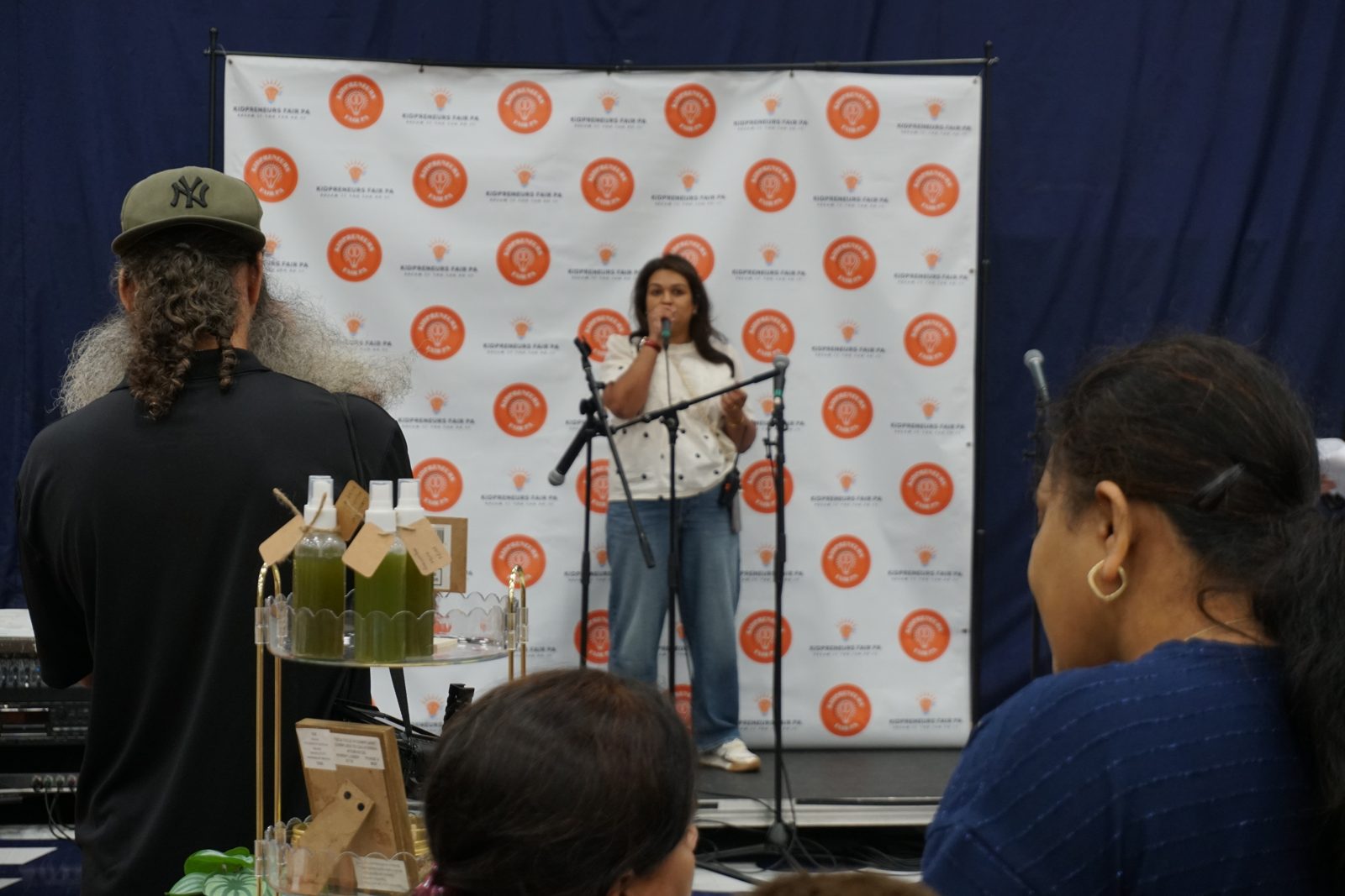 Speaker addressing the fair audience on stage